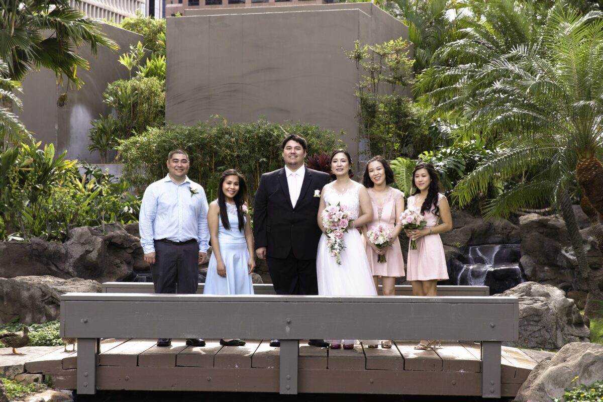 Groom, bride, and their respective bridal parties posing for the camera.