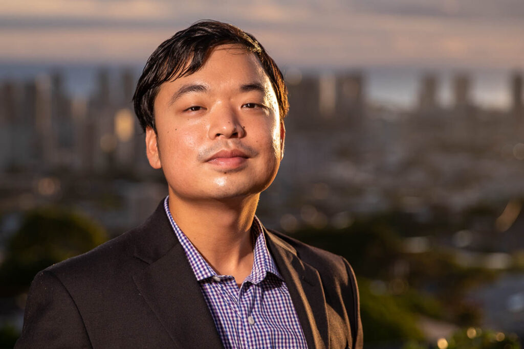 Man in formal work attire standing in front of city