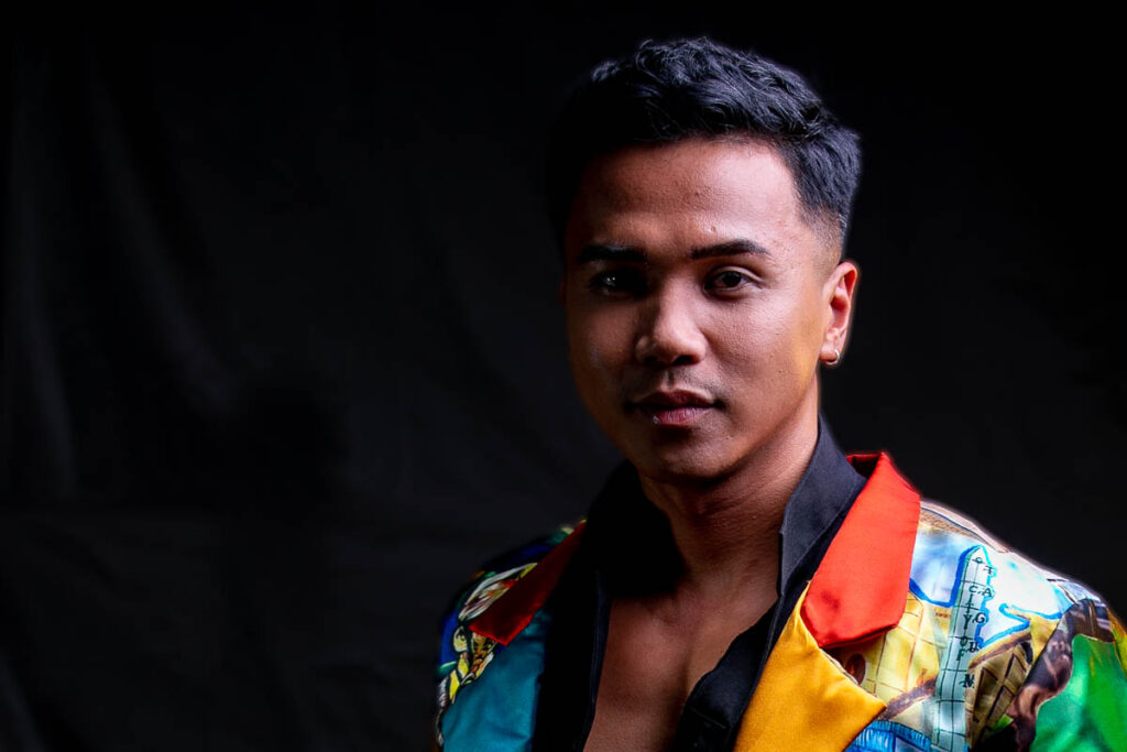 Man in colorful blazer posing headshot